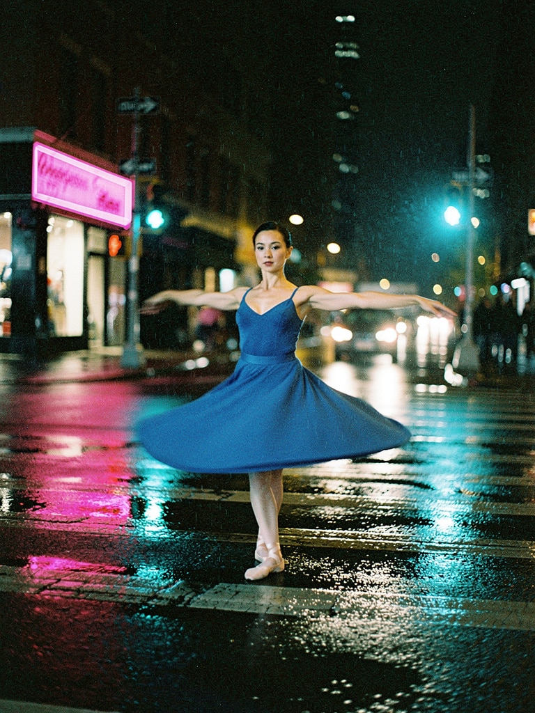 A ballerina dancing in neon rain